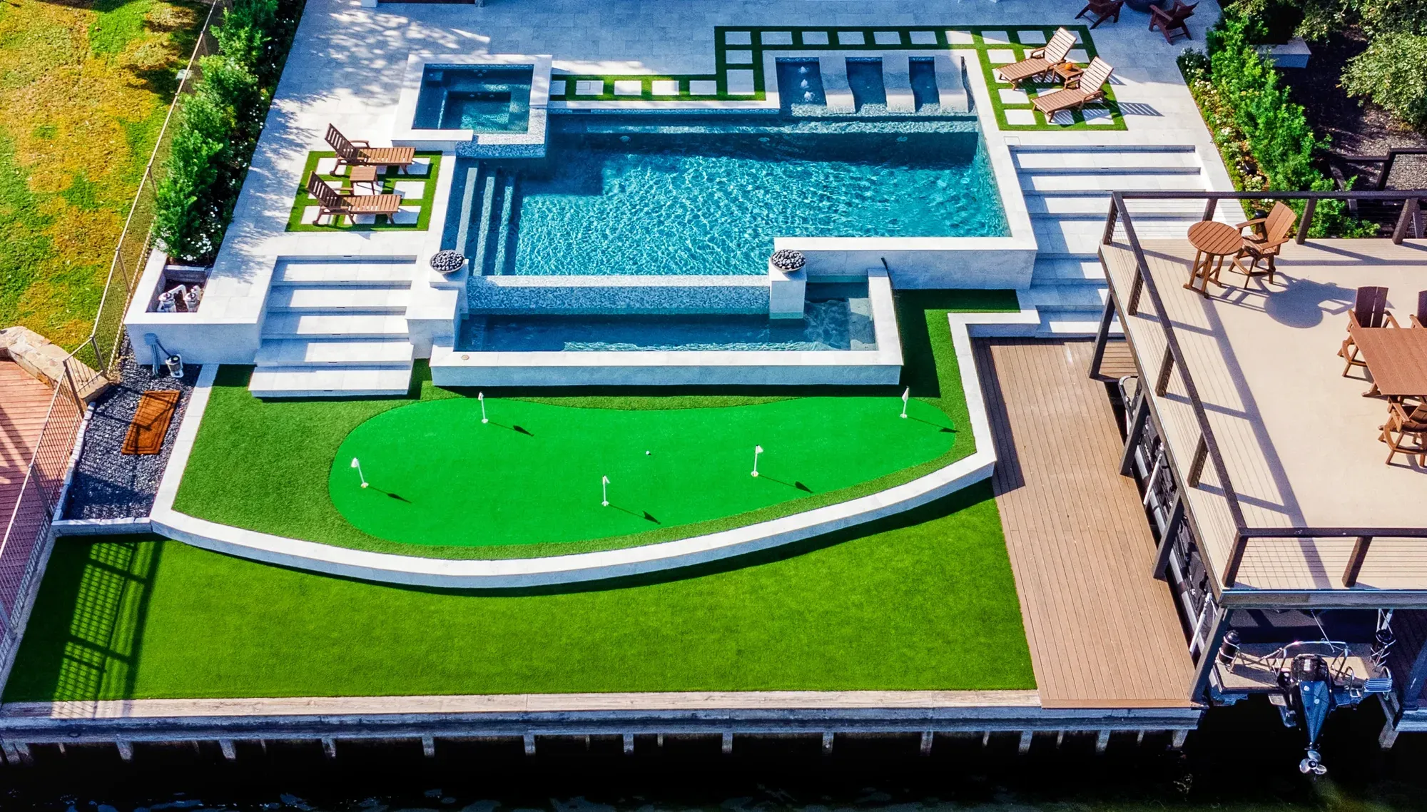 A bird's-eye view of the pool terrace, practice green and lakeside deck