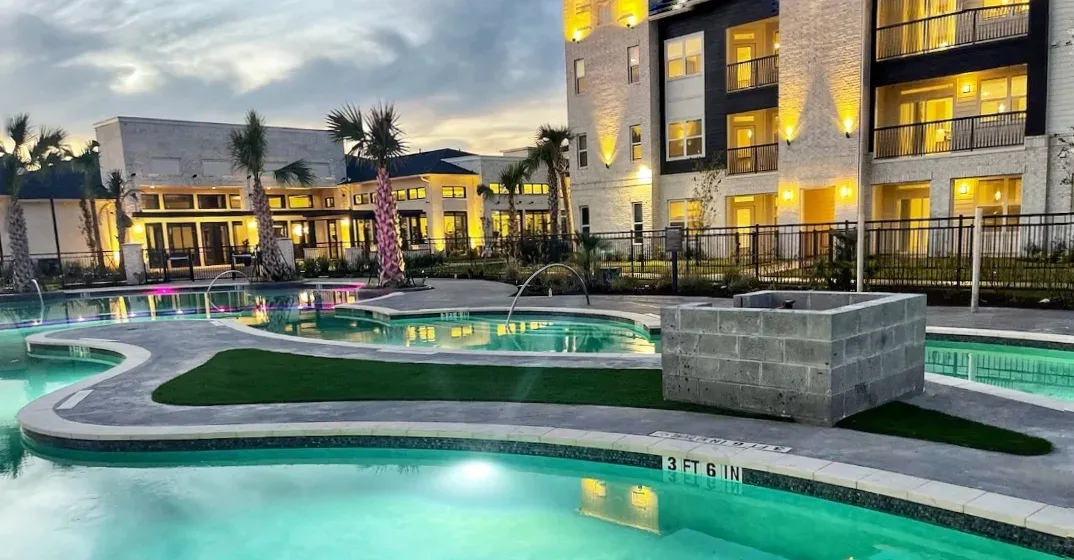 The lazy river and its turf island from the far side at dusk