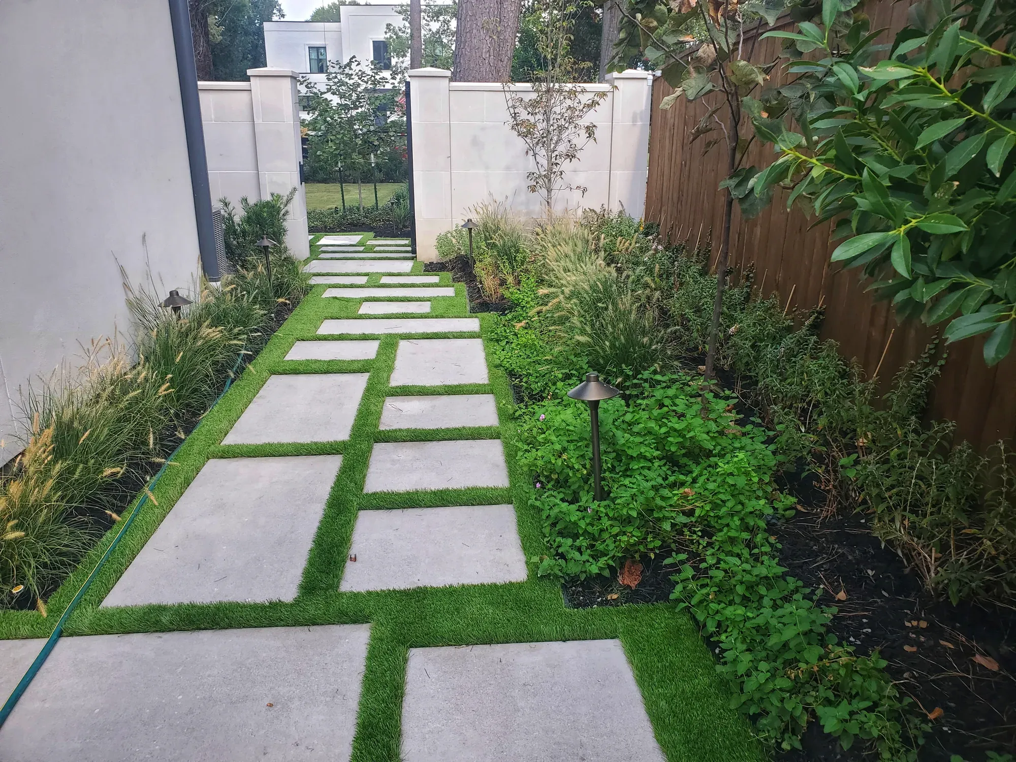 Stone treads with turf joints running down a narrow planted side passage