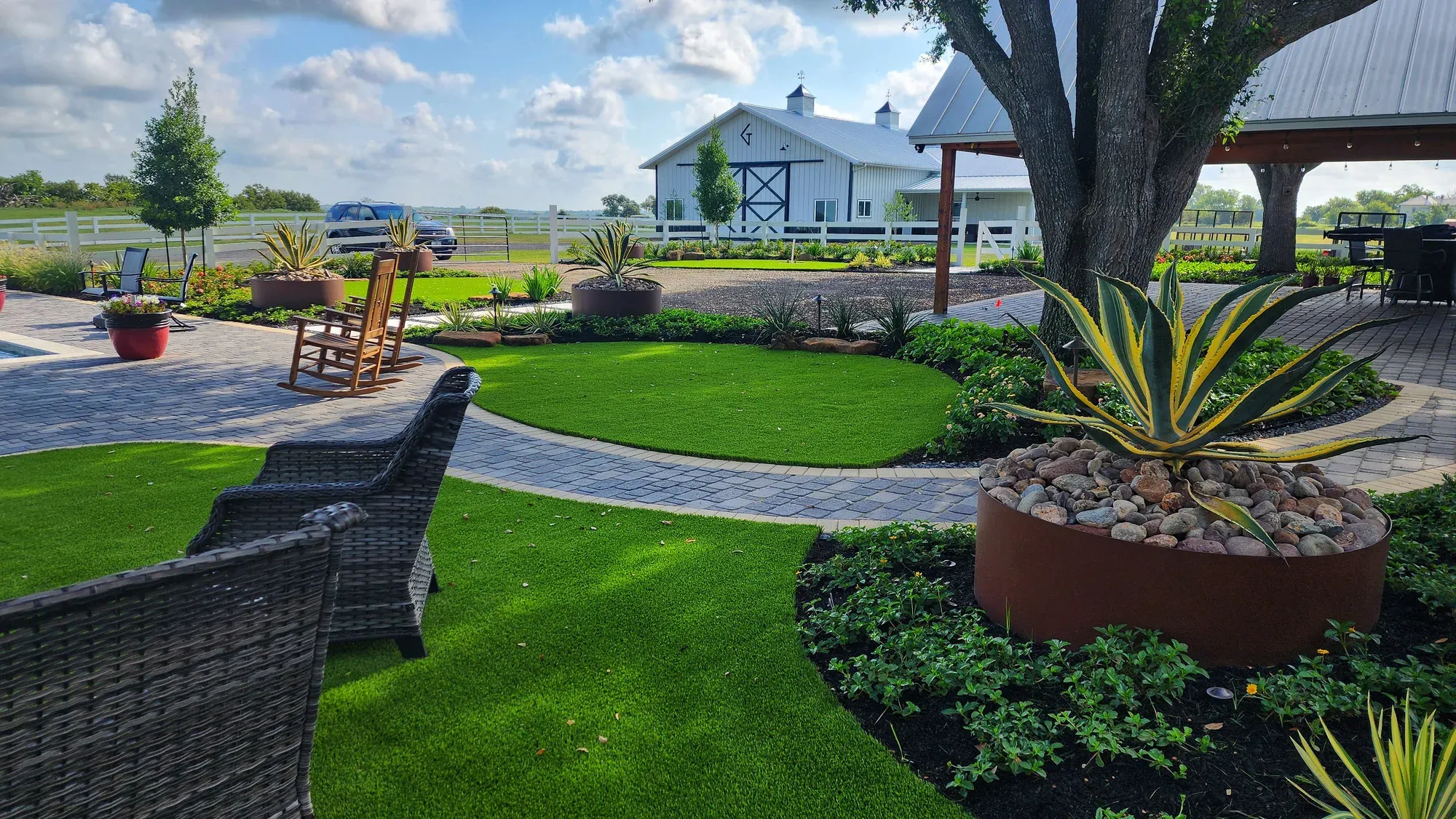 Artificial turf lawn and putting green beside a back-yard pool, installed by TNT Turf