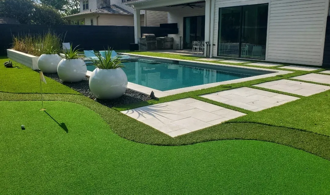 The pool, planters and curved lawn from further back